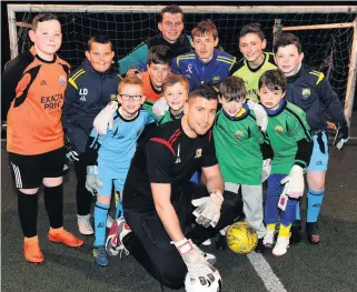  ??  ?? Safe hands Neil Parry, front row centre, and Chris Henry, back row, with the EKYC goalkeeper­s