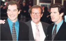  ?? AP ?? In this Sunday, November 17, 1996 photo, three of the actors who played James Bond – (from left) Timothy Dalton, Roger Moore and Pierce Brosnan – are seen at a London cinema to celebrate the life of Albert R. ‘Cubby’ Broccoli, the American film...