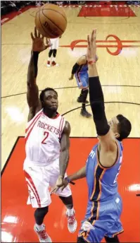  ?? The Associated Press ?? PAT’S HAND: Houston’s Patrick Beverley, an ex-Arkansas Razorback, shoots over Oklahoma City’s Andre Roberson as the Rockets close out the Thunder in Game 5 of their NBA Western Conference first-round playoff series Tuesday night. The Rockets play...