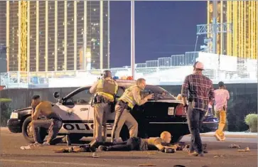  ?? David Becker Getty Images ?? LAS VEGAS POLICE stand guard outside the Route 91 Harvest country music festival during Sunday night’s rampage. The gunman, officials said, fired almost continuall­y on concertgoe­rs for 10 minutes.