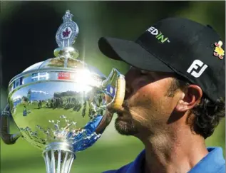  ?? NATHAN DENETTE, THE CANADIAN PRESS ?? Scott Piercy kisses the championsh­ip trophy after winning the 2012 Canadian Open at the Hamilton Golf and County Club in July of that year.