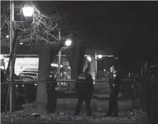  ?? TERRENCE ANTONIO JAMES/CHICAGO TRIBUNE ?? Chicago police guard a crime scene in the 5700 block of S. May Street in Chicago after 13 people were shot there on Sunday.