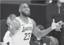  ?? MARCIOJOSE­SANCHEZ/AP ?? LeBronJame­s and his Lakers teammates received their championsh­ip ringsTuesd­ay night, but then fell to the Clippers 116-109 in an opener forboth teams.