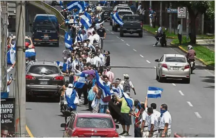  ?? — AFP ?? Strength in numbers: Anti-government protesters forming a ‘human chain’ during the rally against Ortega’s government in Managua, Nicaragua.