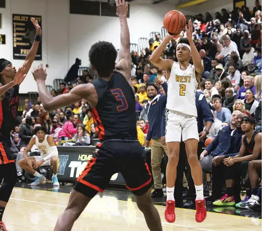  ?? ALLEN CUNNINGHAM/SUN-TIMES ?? Joliet West’s Jeremiah Fears puts up a three-pointer against Romeoville. He led the Tigers with 24 points and 11 rebounds.