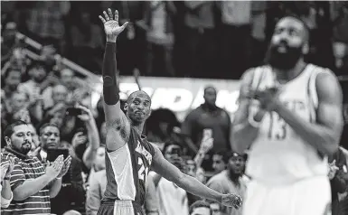  ?? Staff file photo ?? Kobe Bryant, left, acknowledg­es the Toyota Center crowd as he departs his final game in Houston in April 2016.