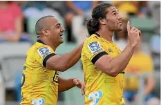  ?? GETTY IMAGES ?? Hurricanes winger Kobus van Wyk, right, celebrates one of his three tries on Saturday.