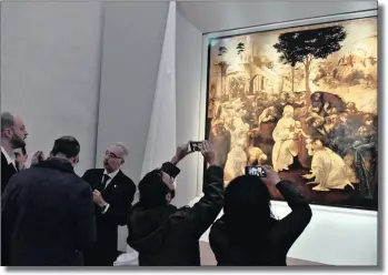  ?? PICTURE: AP ?? Visitors take pictures of Leonardo da Vinci’s Adoration of the Three Wise Men, which was returned to the public at the Uffizi museum after six years of study and restoratio­n, in Florence, Italy, yesterday. Painted in 1481, it is one of the most...