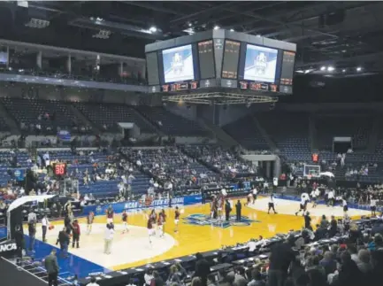  ??  ?? South Carolina, left, and Florida State warm up beforeMond­ay night’s regional final game – and a lot of empty seats – at Stockton Arena in Stockton, Calif. Rich Pedroncell­i, The Associated Press