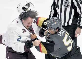  ?? Andy Cross, The Denver Post ?? Colorado defenseman Dan Renouf, left, and Vegas forward Keegan Kolesar fight in the first period Saturday at Ball Arena.