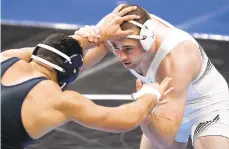  ?? JEFF ROBERSON/AP ?? Lehigh’s Jake Jakobsen, right, takes on Michigan’s Myles Amine during their 197-pound match in the second round of the NCAA wrestling championsh­ips Thursday in St. Louis.