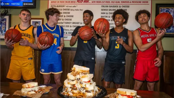  ?? Post-gazette.com. Lucy Schaly/Post-Gazette ?? The Post-Gazette Fabulous 5 players are “almost famous” because of their talent, and they enjoy a laugh around Primanti Bros. “almost famous” sandwiches, at a store in Moon Township. Players are, from left, Thomas Jefferson’s Evan Berger, Hampton’s Peter Kramer, Lincoln Park’s Meleek Thomas, Lincoln Park’s Brandin Cummings and Moon’s Elijah Guillory. View a Fab 5 video at