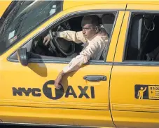  ?? /Reuters ?? King of the road: A taxi driver in Times Square in New York. Ride-hailing apps broke a monopoly whose service was seen as unsatisfac­tory.