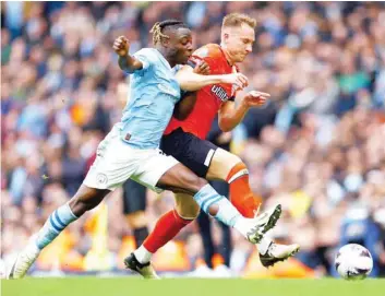  ?? — REUTERS ?? Manchester City’s Jeremy Doku in action with Luton Town’s Cauley Woodrow.