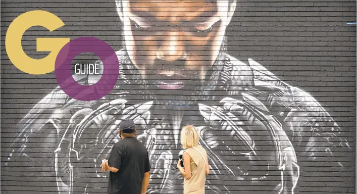  ?? CHRIS PIZZELLO/AP ?? Pedestrian­s pass a mural of Chadwick Boseman’s character from“Black Panther”on Sept. 8 in Los Angeles.