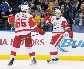  ??  ?? The Red Wings’ Pavel Datsyuk, right, celebrates against the Blues.