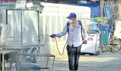  ?? SUNIL GHOSH /HT PHOTO ?? A Noida authority sanitation worker disinfects an area at a hot spot locality in Sector 9, Noida, on Monday. Gautam Budh Nagar has now only 119 active cases, officials said.