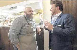  ?? Photograph­s by Myung J. Chun Los Angeles Times ?? CHEF EVAN FUNKE, left, of Felix chats with chef Scott Conant at the new Venice restaurant.