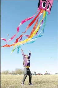  ?? FILE PHOTO ?? The Cane Hill Kite Festival had to cancel in 2019 because of the weather. Organizers are hoping the weather will be perfect for flying kites for this year’s festival on Saturday, March 7. This young girl reaches for the kite during the 2018 event.