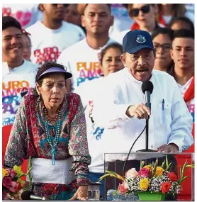  ?? — AFP ?? Pointing a finger: Ortega delivering a speech next to Murillo during the 39th Anniversar­y of the Sandinista Revolution at La Fe square in Managua.