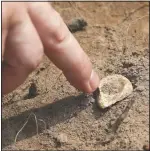  ??  ?? A participan­t points to a piece of chert, a kind of stone Native Americans used for tools and weapons, which was among the items uncovered.