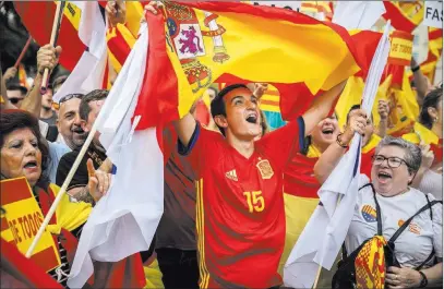  ?? Santi Palacios ?? People wearing the colors of Catalonia and Spain celebrate the country’s national day Thursday in Barcelona. The Associated Press