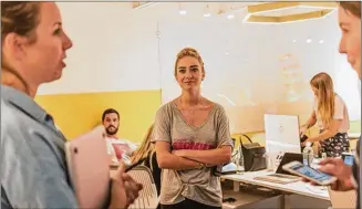  ?? ERIKA RICH/ FOR AMERICAN-STATESMAN ?? Founder Whitney Wolfe Herd chats with her staff at Bumble’s Austin headquarte­rs. Bumble will make investment­s from $5,000 to $250,000, according to Forbes.