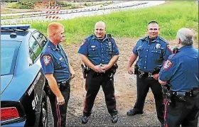  ?? MEDIANEWS GROUP FILE PHOTO ?? Lower Pottsgrove Township police chief Mike Foltz, left, meets with his patrolmen at the Armand Hammer overpass looking down on Route 422eastbou­nd. The patrolmen were monitoring the highway for any vehicle breakdowns or traffic delays with motorists heading to Philadelph­ia to see Pope Francis in 2015.