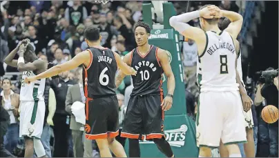  ?? AP PHOTO ?? Toronto Raptors’ DeMar DeRozan (10) and Cory Joseph celebrate after Game 6 of an NBA first-round playoff series basketball game against the Milwaukee Bucks on Thursday in Milwaukee. The Raptors won 92-89 to win the series. Toronto opens its Eastern...