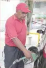  ?? — Reuters ?? An attendant refuels a car at a gas station of Venezuelan oil company PDVSA in Caracas.