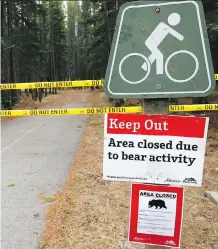 ?? DARREN MAKOWICHUK ?? Signs around the trails of the Kananaskis Country Golf Course warn visitors about the grizzly bears seen in the area.