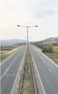  ??  ?? An eerily quiet M66/A56 at Edenfield at 5.30pm on Tuesday after the lockdown