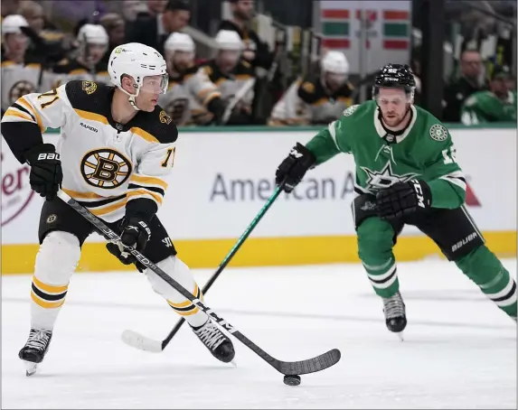  ?? TONY GUTIERREZ — THE ASSOCIATED PRESS ?? Boston Bruins left wing Taylor Hall controls the puck under pressure from Dallas Stars center Radek Faksa, rear, in the first period Tuesday night in Dallas.