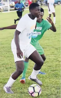  ?? KAVARLY ARNOLD ?? Jevaughn Maxfield of Garey Maceo High School (front) shields the ball from Larry Maitland of Manchester High School during the final of the STETHS Cup at the STETHS Sports Complex on Sunday, August 26, 2018.