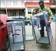  ?? The Associated Press ?? A Pro-Russian activist carries a ballot box away from a polling station in Donetsk, Ukraine, Friday.