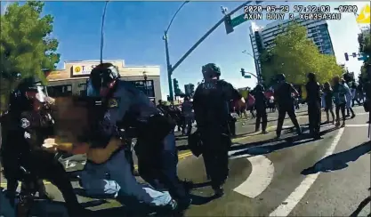  ?? SAN JOSE POLICE DEPARTMENT ?? In a frame from a San Jose police officer’s bodycam video, officers arrest a man, whose face is obscured in the video, during a San Jose protest May 29. Police allege the man attempted and failed to disarm an officer following the declaratio­n that the protest was an unlawful assembly.