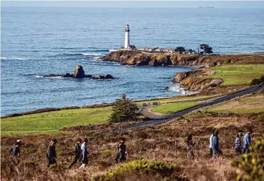  ?? Photos by Stephen Lam/The Chronicle ?? Hikers follow a trail to Wilbur’s Watch in Pescadero. The trail is part of Cloverdale Ranch, a long stretch of land defined by remote beaches, Brussels sprout fields and hills studded with oaks and redwoods.