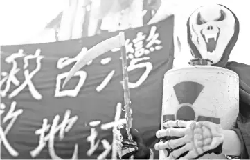  ?? — AFP photo ?? An activist takes part during an annual protest against the use of nuclear energy in front of the Presidenti­al Office in Taipei.