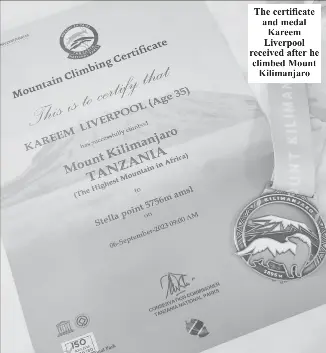  ?? ?? The certificat­e and medal Kareem Liverpool received after he climbed Mount Kilimanjar­o