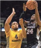  ?? JEFF HANISCH / USA TODAY SPORTS ?? Marquette freshman Theo John (left) had 14 points, six rebounds and five blocked shots against Providence.