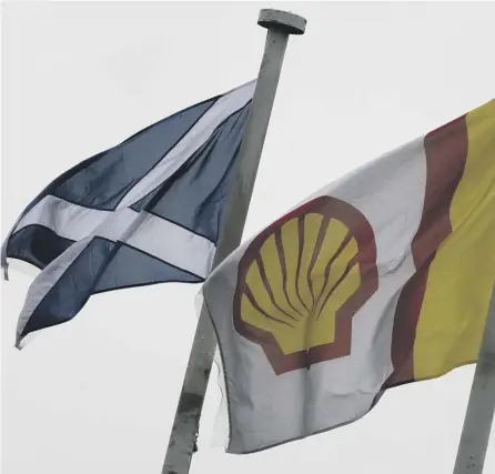  ??  ?? 0 Flags fly outside the Shell Exploratio­n and Production offices in Aberdeen. The company has marked 50 years of production in the North Sea energy sector. Picture: PA