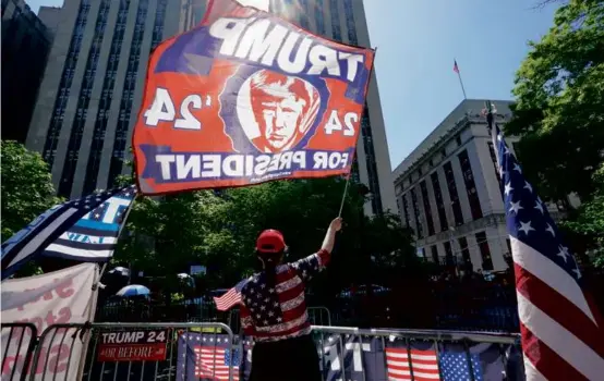  ?? TImOthY a. claRY/POOl/aFP vIa gEttY ImagES ?? A woman waved a Trump flag outside Manhattan Criminal Court during the former president’s trial on Monday.