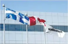  ?? THE CANADIAN PRESS FILES ?? Flags fly outside the Bombardier CSeries plant, on Sept. 28, in Mirabel, Que.