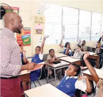  ?? CONTRIBUTE­D ?? Garth Walker, Business Access TV managing director, engages students at the Stella Maris Preparator­y School, St Andrew during Read Across Jamaica Day last week Tuesday.