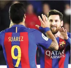  ??  ?? Barcelona strikers, Lionel Messi (R) and Luiz Suarez celebrate after scoring a goal