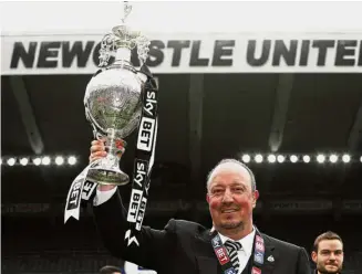  ??  ?? Fearing the drop: Rafa Benitez holding the Championsh­ip trophy last season. The Spaniard hopes to help Newcastle avoid immediate relegation back to the second tier.