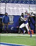  ?? ADRIAN KRAUS / AP ?? Bills cornerback Taron Johnson runs back an intercepti­on for a touchdown during Saturday’s playoff game against the Ravens in Orchard Park, N.Y.