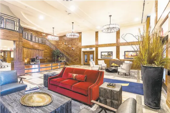  ?? AHM BRANDS ?? The lobby of The Alexander in Bend, Oregon features bespoke details like ornate chandelier­s and a sculpted ceiling.