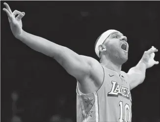  ?? Photograph­s by Mike Stobe Getty Images ?? JARED DUDLEY displays the type of energy he brings after hitting a three-pointer against his former team, the Brooklyn Nets, to give the Lakers a double-digit lead.