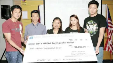  ??  ?? Financial assistance: nepalese students holding the mock cheque which will be handed over to the Believers.